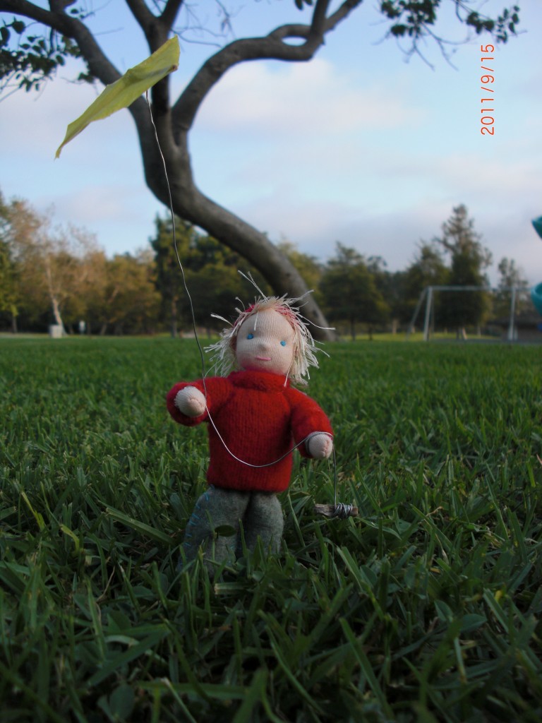 Waldorf Fall Seasons Nature Table Handmade Doll. Boy in Red Lambswool Sweater with Yellow Kite whote view