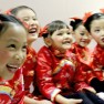 cropped Laughing. Our 10 Gorgeous Traditional Chinese New Year Hexinnian Greeter children dancers in the hallway at Barclay Theatre bac