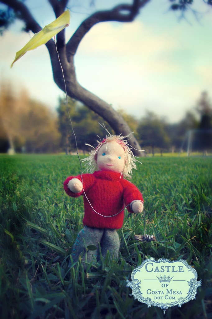 131018 Nova Scotia kite boy in red lambswool sweater flying yellow oil paper kite with gleaming kite string