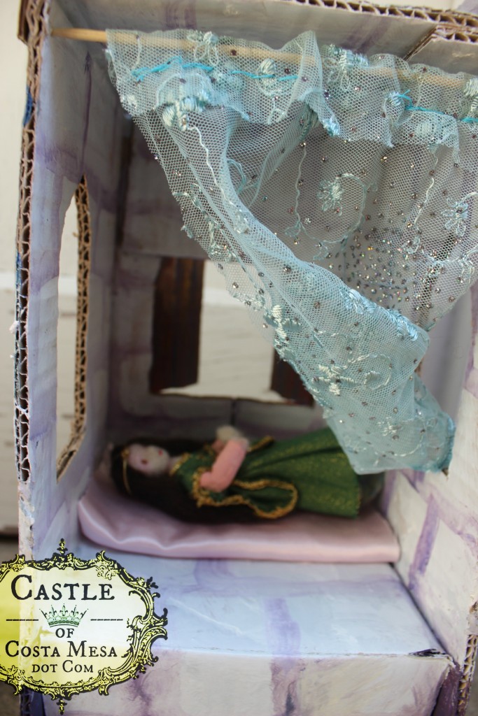 5777 150602 Lady Princess Emerald languishing in bed in her corrugated cardboard tower castle with lace curtains by Castle of Costa Mesa