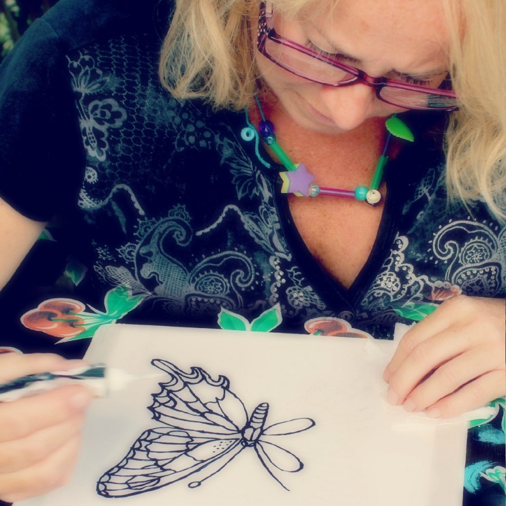 130910 square. Denise painting a swallowtail butterfly on silk using black Gutta resist