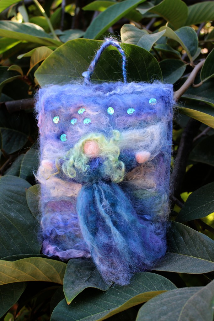 Cathrine's needle-felted guardian angel masterpiece, finished. With stitched loose iridescent sequins. needle felted painting Christmas tree ornament. Costa Mesa Wednesday Morning Waldorf craft group. Steiner Waldorf School of Orange County. CastleofCostaMesa.Com