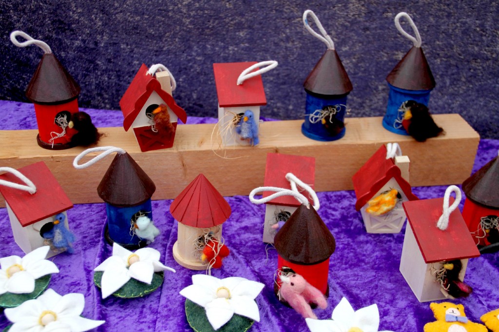 Felted birds in wooden birdhouses