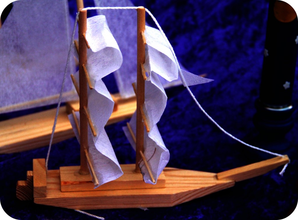 double masted wooden sailboat with white sails