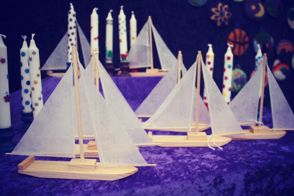 wooden sailboats and beeswax decorated candles