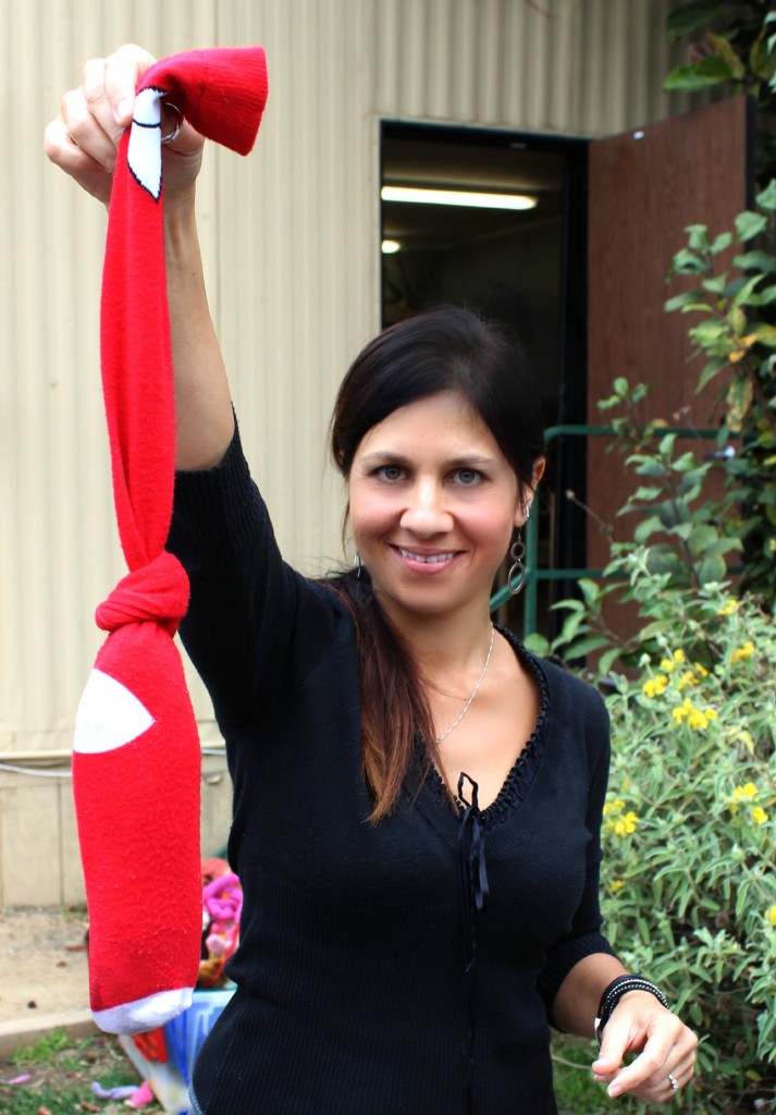 130123 Renuka holding up Christmas stockings with rolled up Artfelt scarf ready for felting in the dryer.