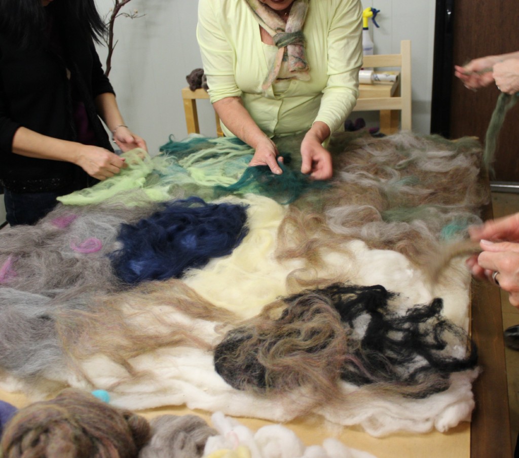 130130 sketching out wet felted playscape with thin layers of colorful roving