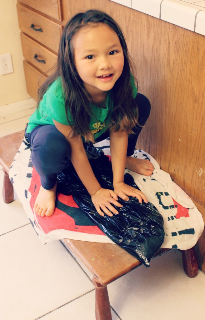 130228 Nunu sitting on rolled up mat of wet-felting project