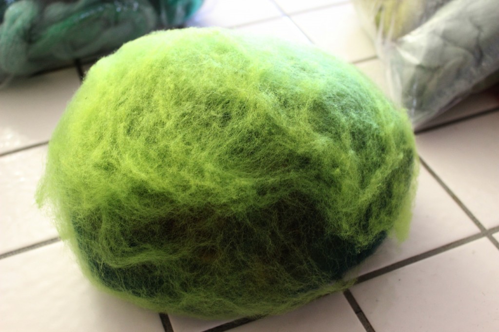 130315 Added thin layers of green fleece and roving on extra large easter egg. Ready for liquid soap and boiling water