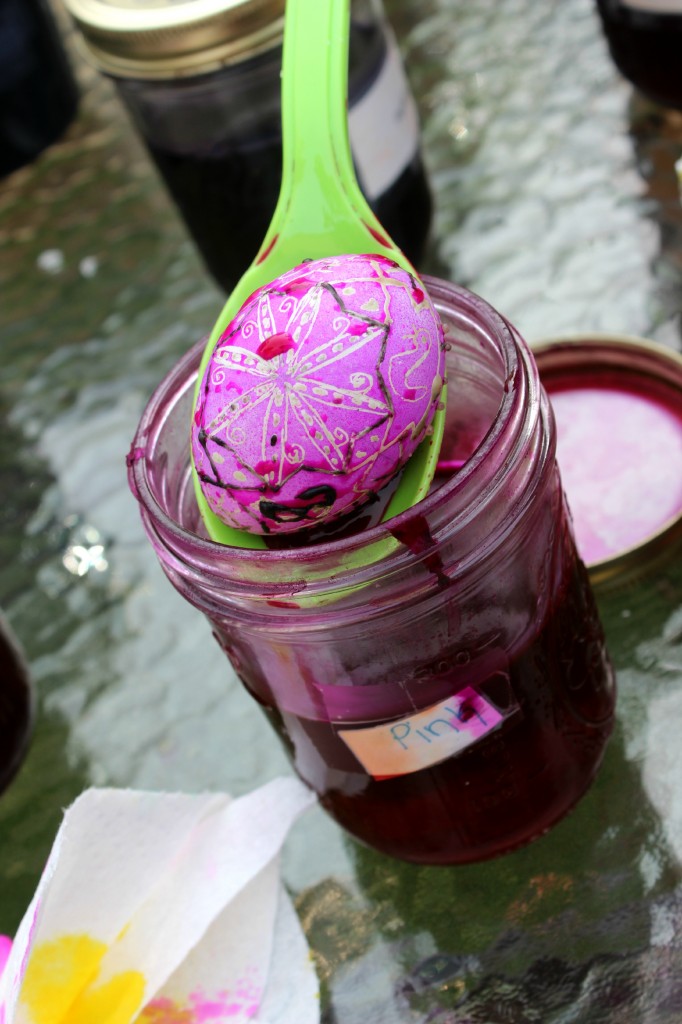 130320 Ukrainian egg dipped in pink dye with a large spoon