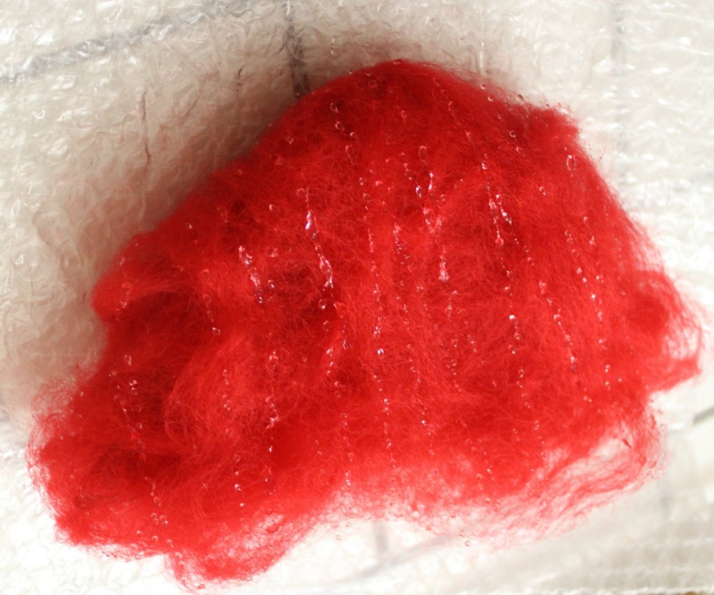 130328 Drizzling liquid dishwashing detergent onto wool roving for wet-felting