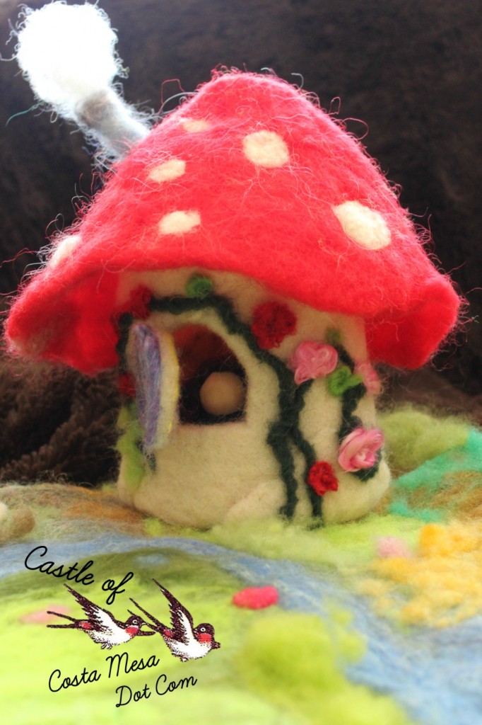 130408 Nunu's toadstool cottage with brunette peg doll. Logo