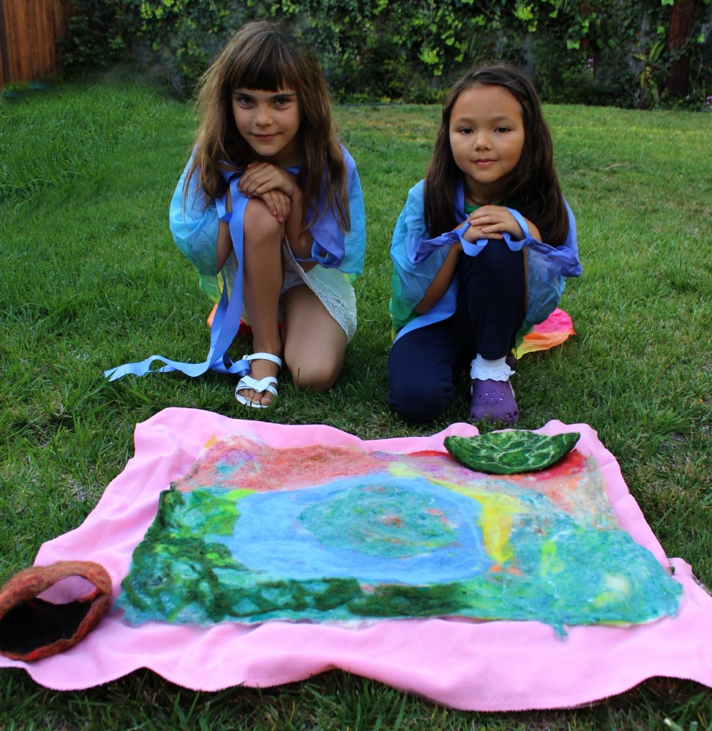 130403 Anicka and Nunu with the wet-felted playscape unrolled from polyester wrapping from the dryer