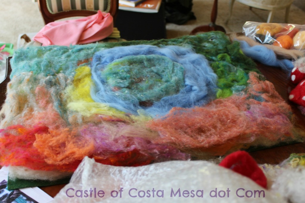 130403 layering colorful PeaceFleece wool roving on playscape landscape blanket