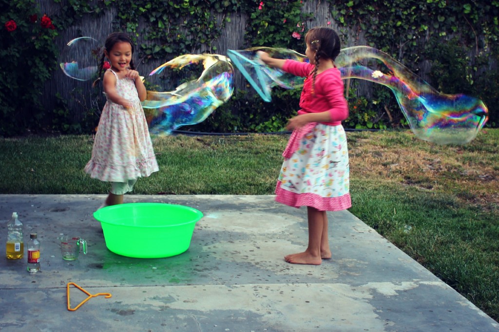 130425 Nunu aand Anicka swing wands of giant bubbles at each other