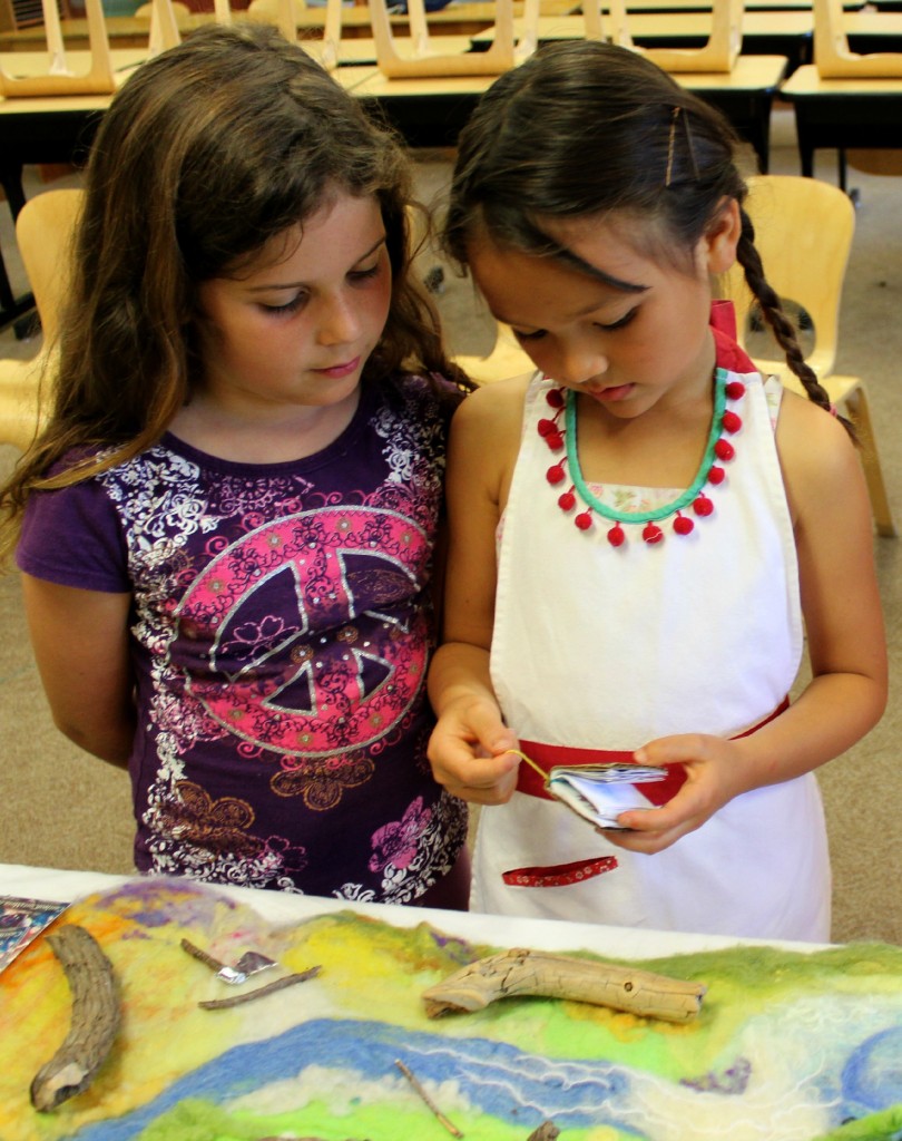 130425 Nunu showing handmade miniature fairy tale book to Jadyn.