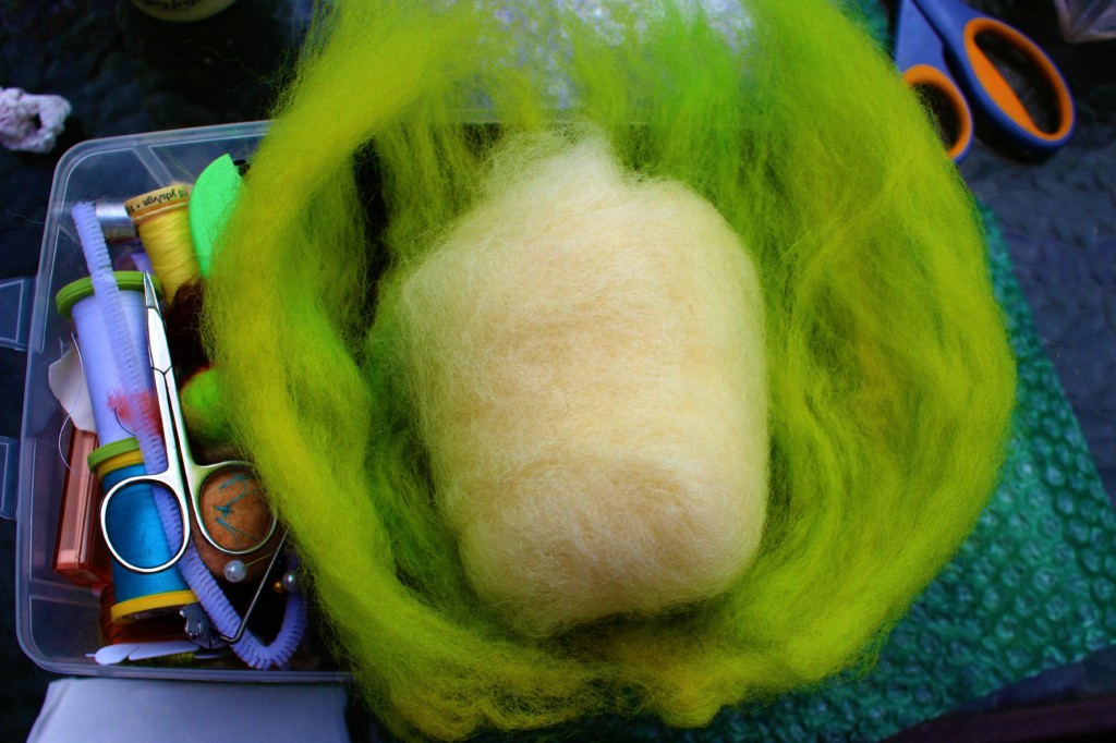 130501 Jzin's wet-felted soap white batting wrapped in chartreuse colored wool roving on Jzin's craft box