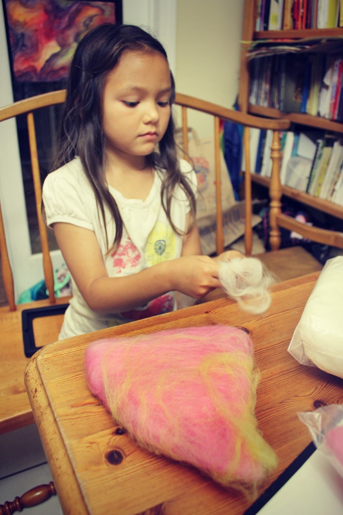 130519 Nunu laying thin layers of wool tops onto baby flower fairy hat for wet-felting