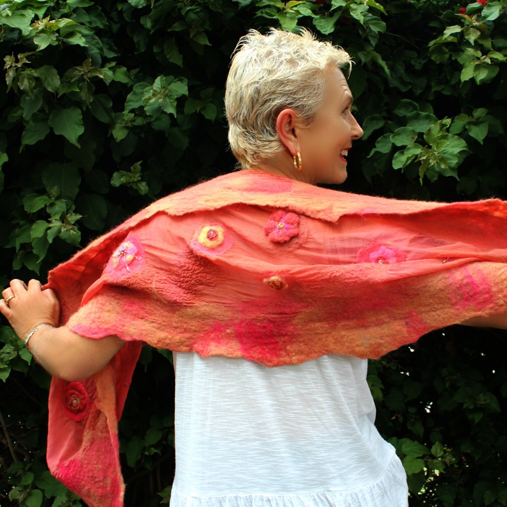 130605 Rachel Skelly modeling Gisela's nuno felted salmon colored silk beaded scarf back view. square cropped
