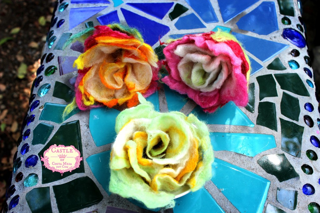 130530 3 newly finished crafted wet-felted roses on Rachel Skelly's mosaic bench