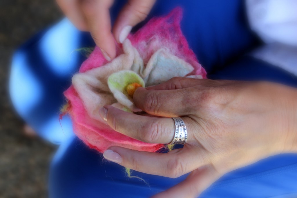 130530 close up view Christine folding petals of wet-felted flower to form rosette swirl of a rose