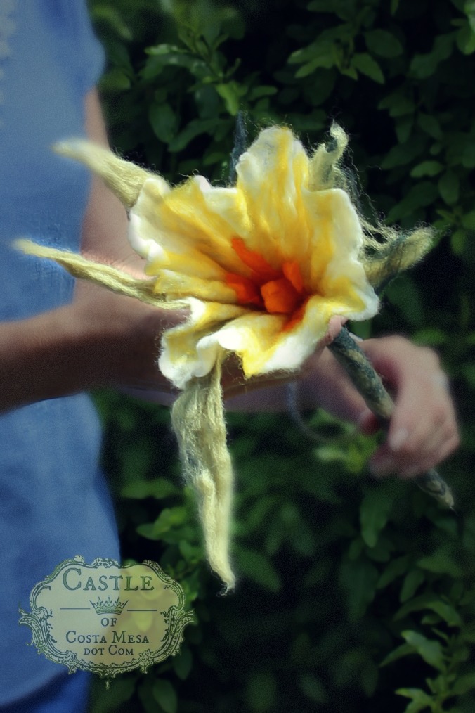 130605 Christine holding Josephine's wet-felted white flower with large light green sepals and orange carpel and stamens..