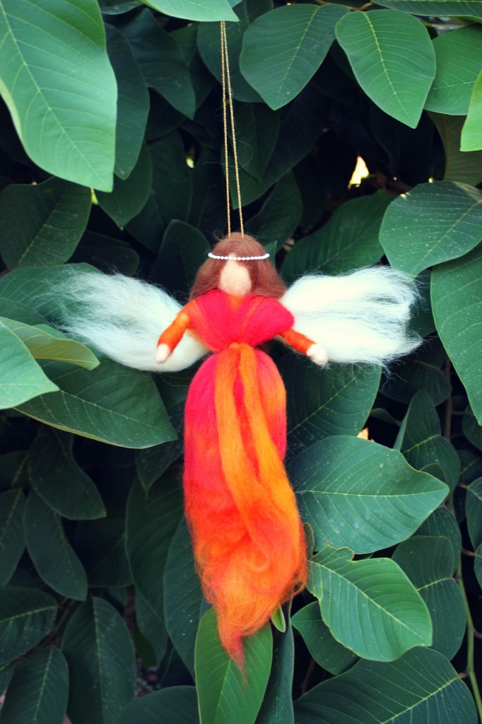 130924 Liz Burnett's fire orange autumn pulled wool fairy angel ornament hanging in the cherimoya tree