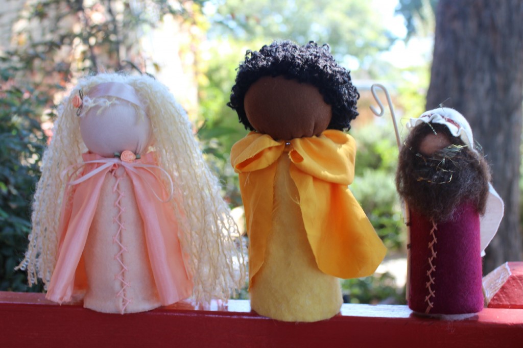 131001 Josephine's blonde princess, Jzin's Nubian prince and Christine's Nativity shepard table top puppet dolls on a red ledge