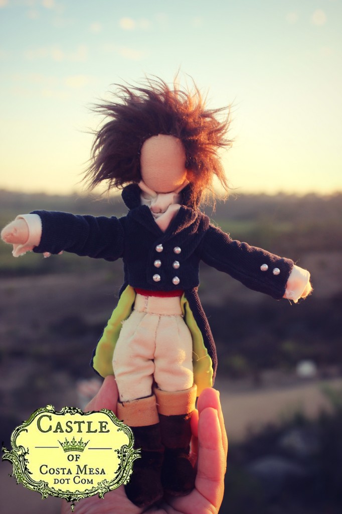 131002 Hans the Composer doll in sunset held by hand with logo