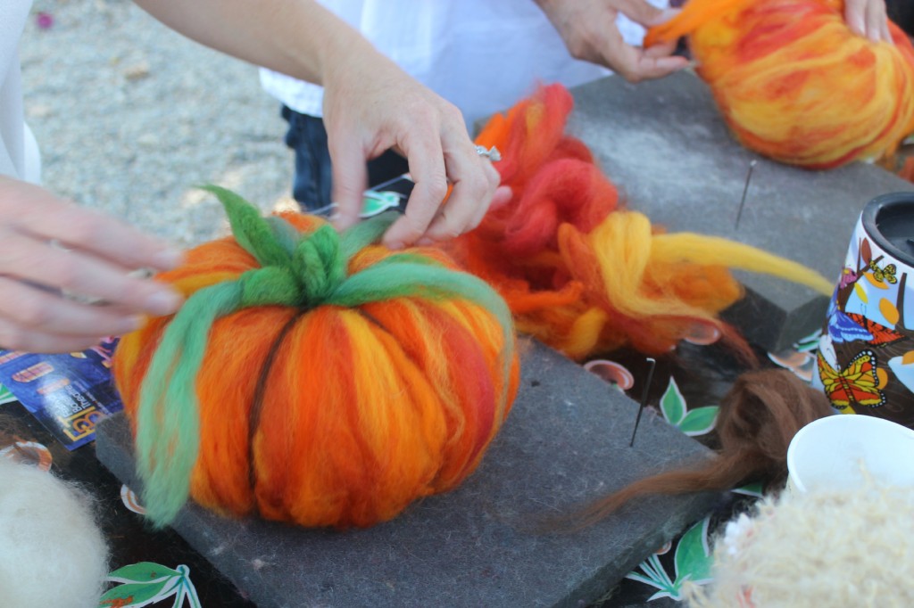 131015 Gina adding stems, leaves and tendrils to her felted pumpkin craft project.