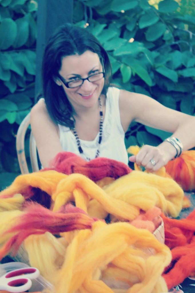 131015 Heather amidst a pile of hand-dyed natural wool top roving