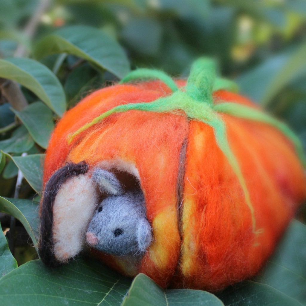 131015 square cropped. Josephine's needle-felted mouse peering out the door of his orange pumpkin house front door on foggy morning