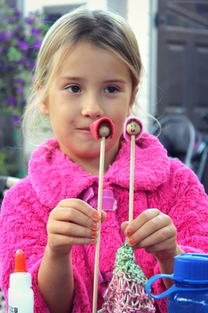 131029 Mia and her illustrated doll faces on her handmade wooden knitting needles.