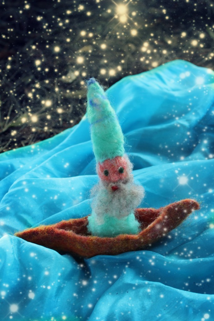 131030 Nunu's needle-felted Merlin doll sailing on a brown pod shaped little wet-felted boat on a starry night.