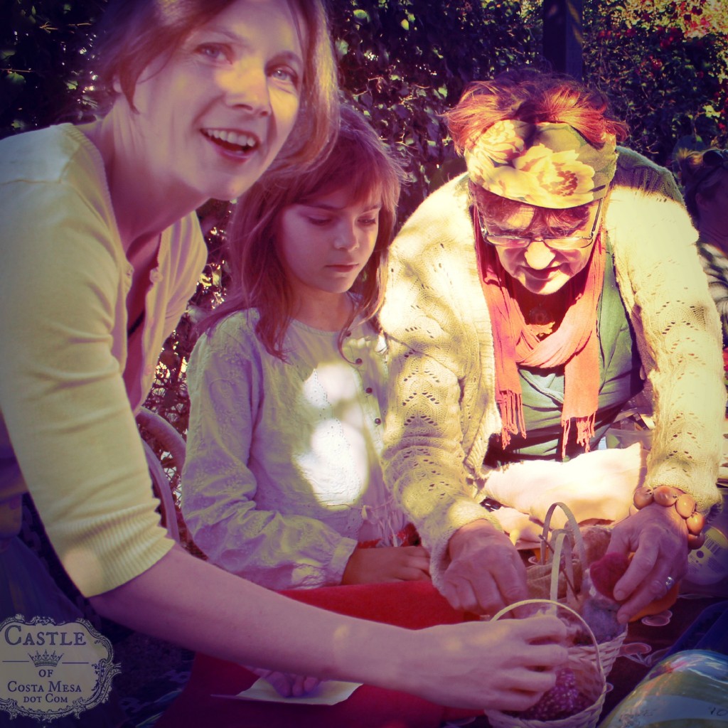 131105 Alena and Anicka admiring Gisela's handmade dolls in baskets with logo