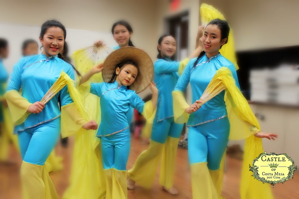 140201 Nunu flanked by fairy girls teenage folk dancers with logo