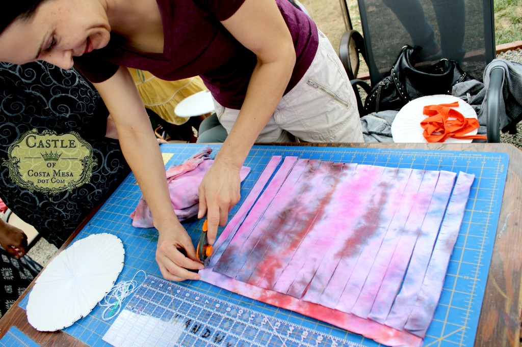 140908 Melissa cutting tie-dyed T-shirt into 1 inch wide strips for making T-shirt yarn 2