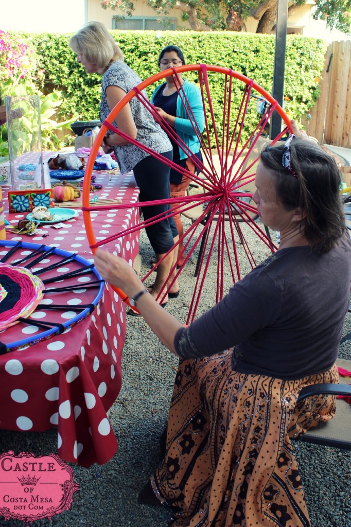 140923 Liz examining the string spokes on her hula hoop wheel loom for weaving T-shirt yarn bath rug throw 2