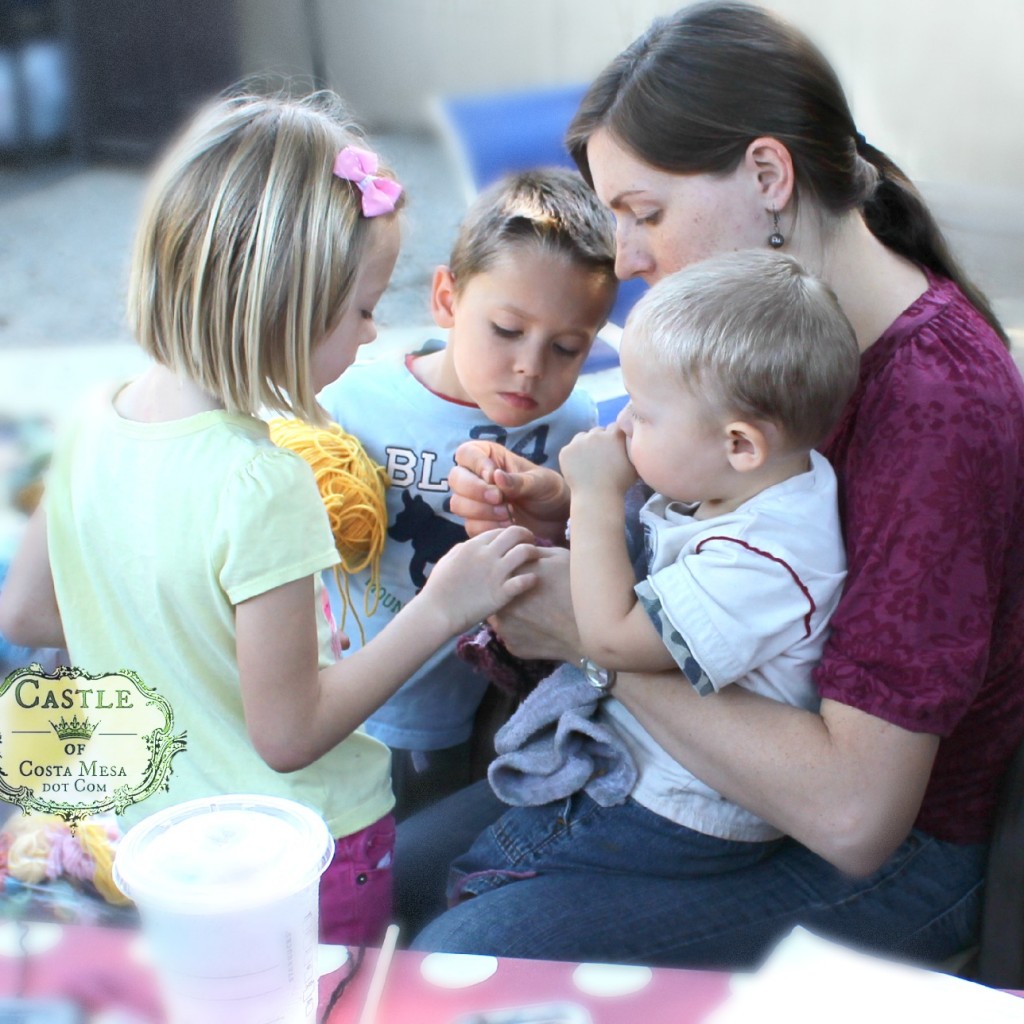 141007 Laura stitching knitted cat with her constellation of children 2