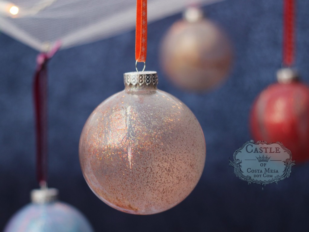 141206 festive glass balls Christmas tree ornaments hanging on ribbons.