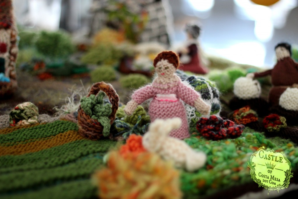 1632 150530 Knitted lady in pink in the village garden