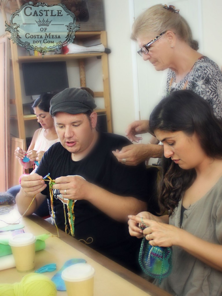 2764 150915 Josh crocheting a pair of slippers for his wife flanked by Yvonne, Christine and Roxanna