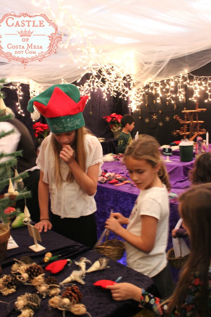 4573 151210 carefully selecting gifts while shopping at WSOC Elves Workshop