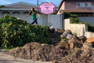 190415 Elena jumping on piles of logs in driveway L